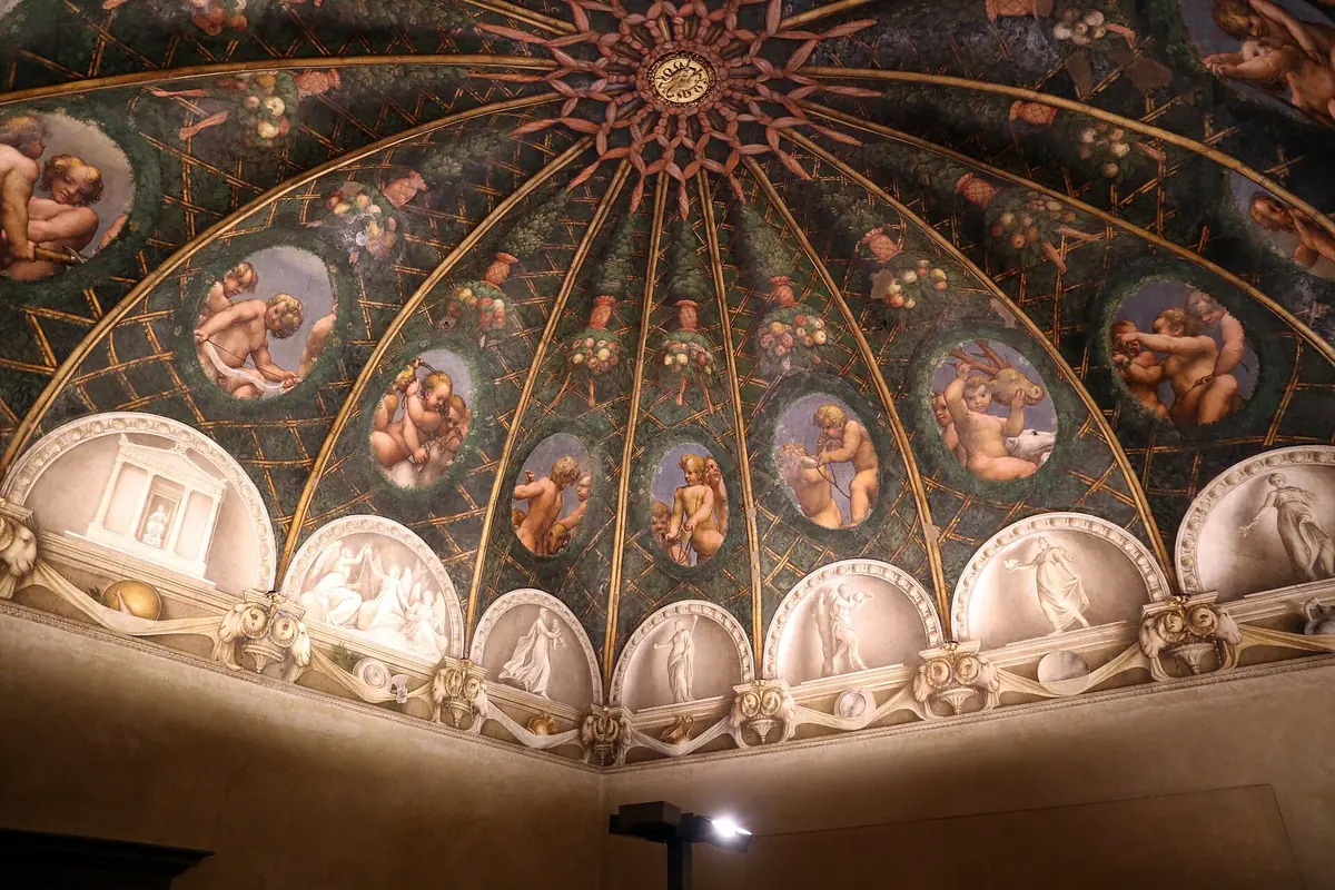 Correggio's frescoed vault with putti in ovals in the Camera di San Paolo, Parma