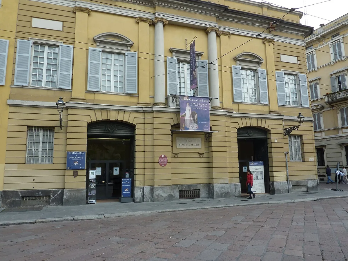 Yellow facade of the Palazzo di Riserva, home of the Museo Glauco Lombardi in Parma