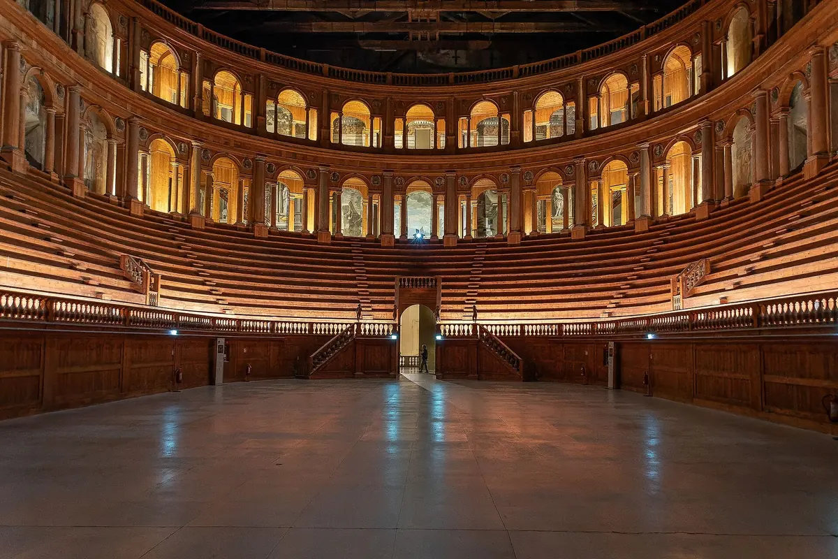 Wooden tiers and arched loggias of the Teatro Farnese in Parma, seen from the stage floor