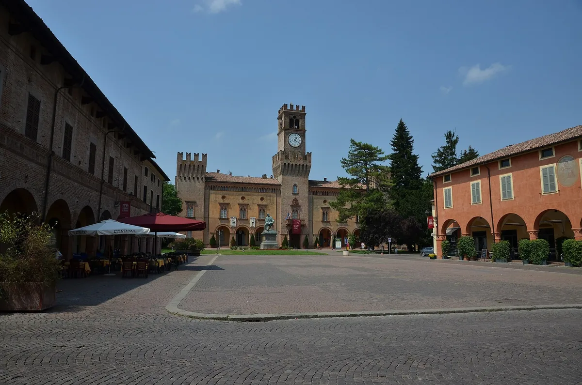 Piazza Verdi in Busseto with the Rocca Pallavicino clock tower and arcaded houses