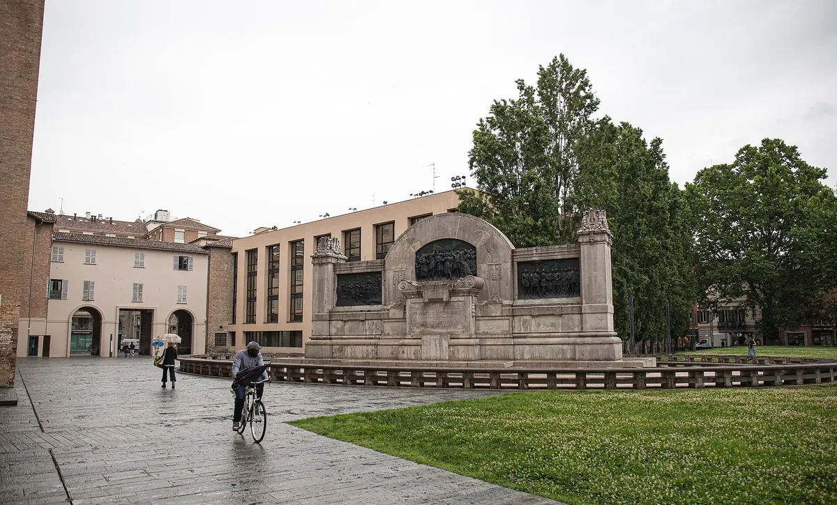 Monument to Giuseppe Verdi in Piazzale della Pace, Parma, with a passing cyclist